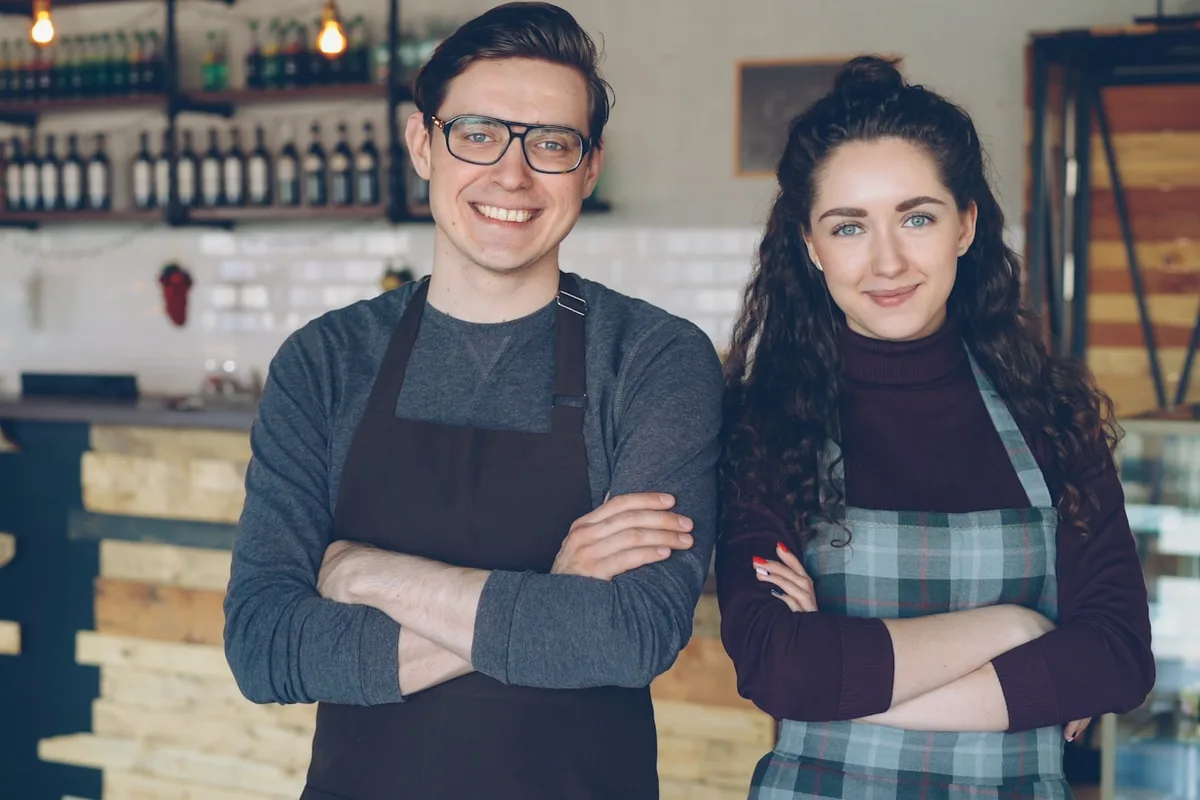 Cafe owners working together behind the counter