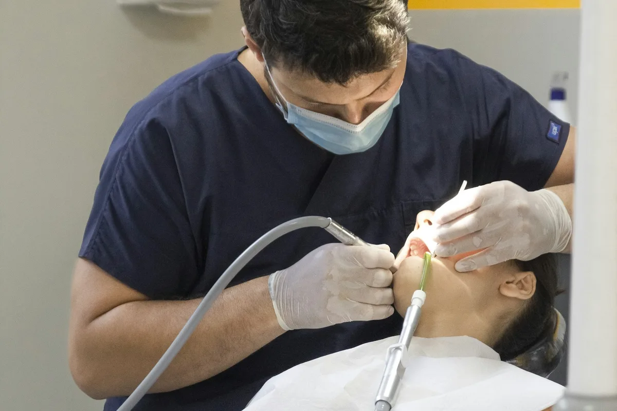 Dentist providing care in a clinic