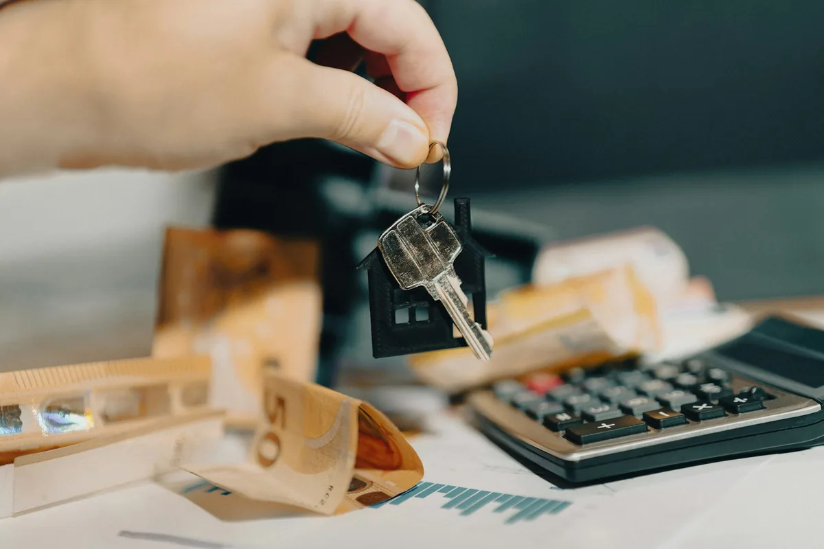 House key held above a calculator