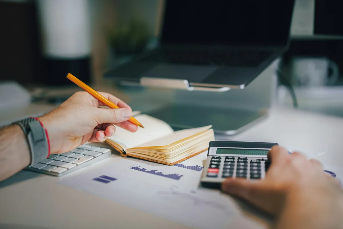 Accountant working with a calculator and notebook