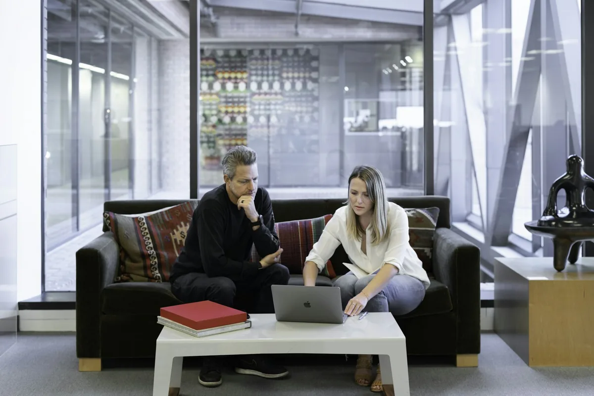 Real estate professionals reviewing records on a laptop