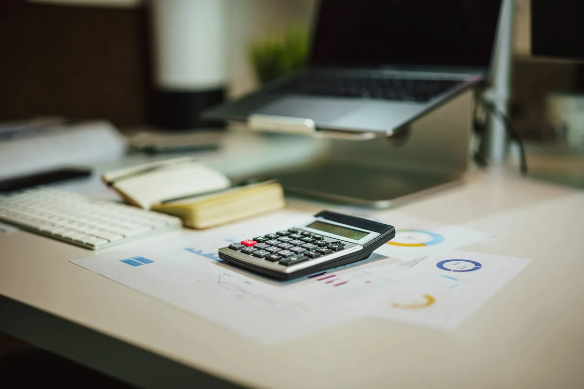 Corporate tax figures reviewed with a calculator
