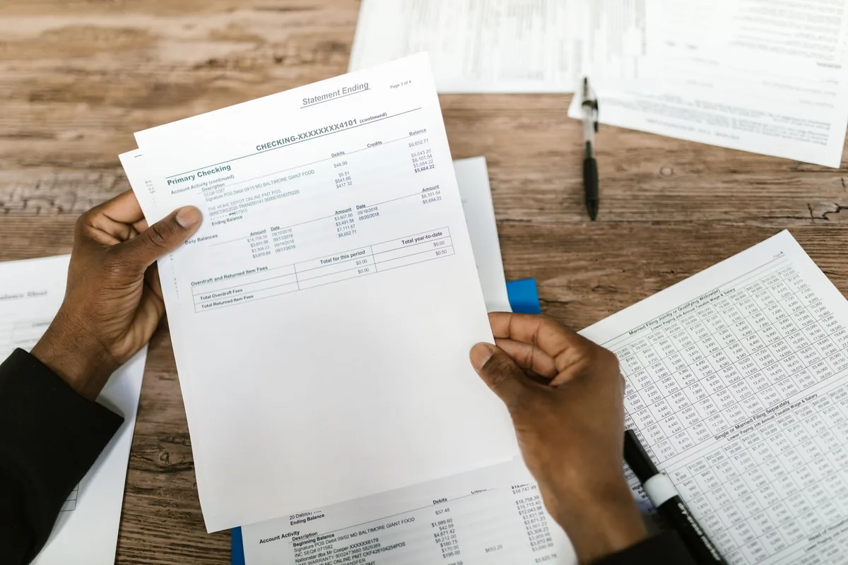 Hands reviewing financial forms for a departure tax filing