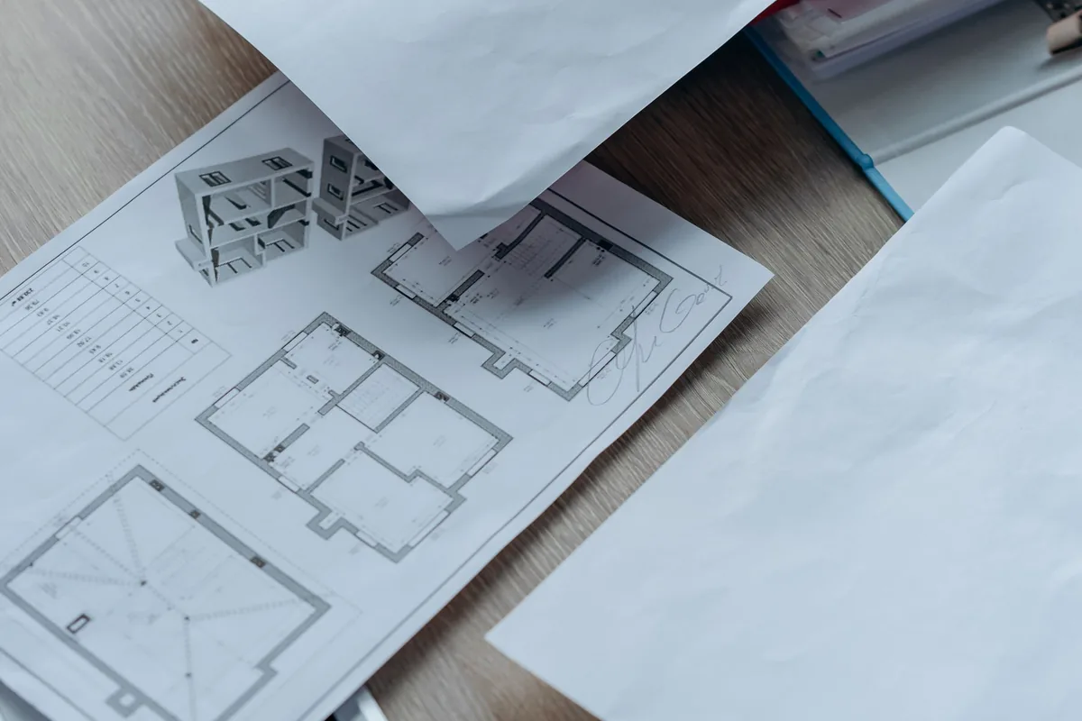 Architectural plans and paperwork used to calculate home purchase costs