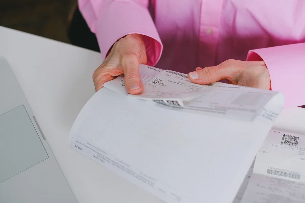 Person organizing receipts for a tax adjustment