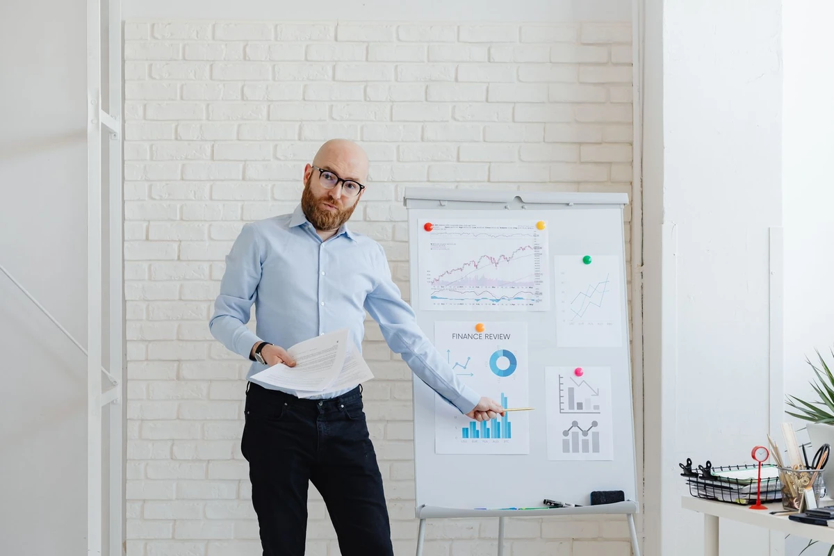Financial advisor explaining business charts on a flipchart