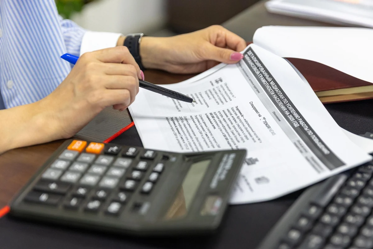 Professional calculating figures from financial documents