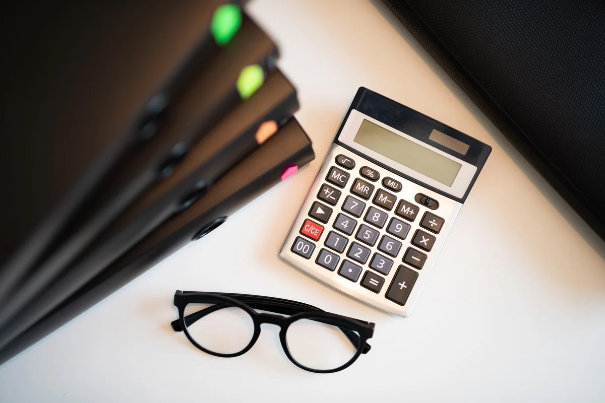 Calculator, folders and organized documents for an annual filing