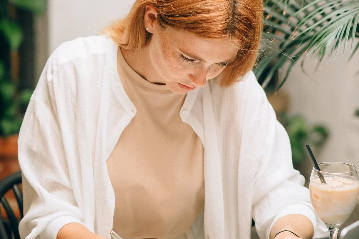Woman reviewing financial documents on a laptop