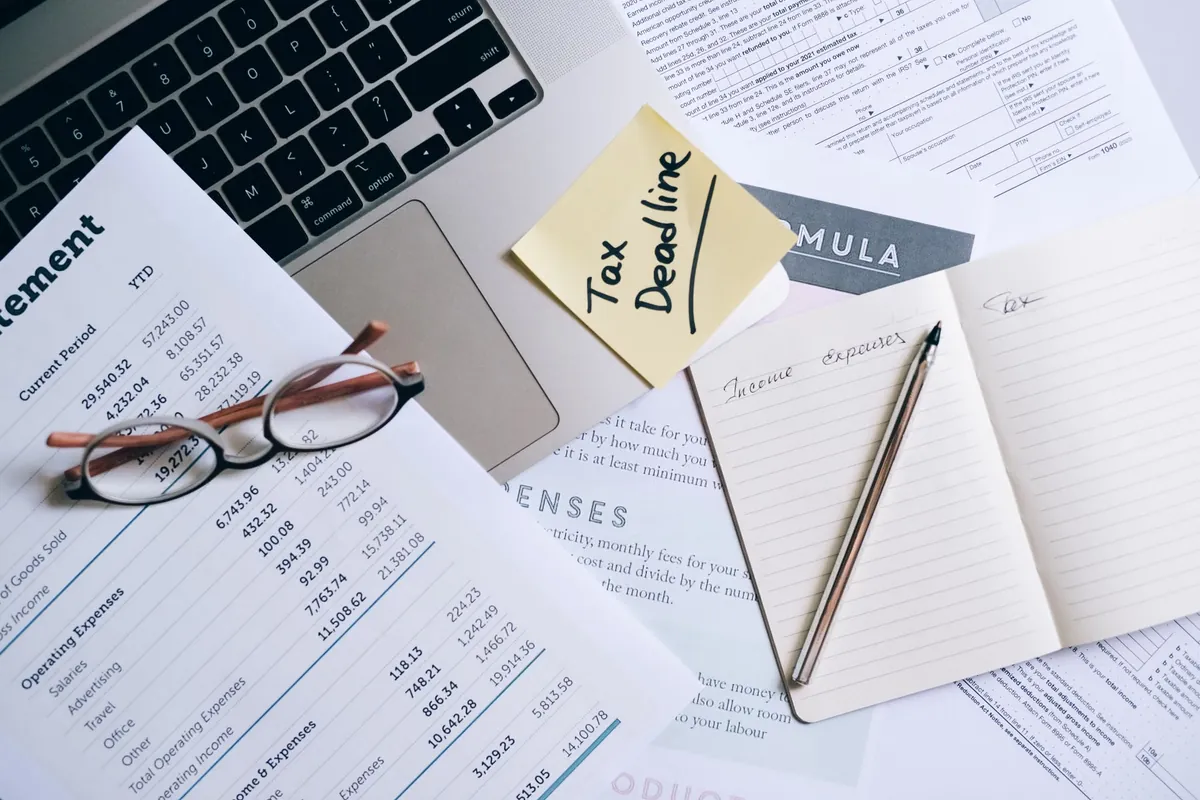 Laptop and tax documents prepared for an online adjustment