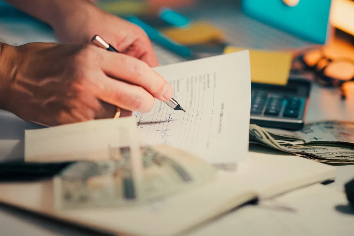 Financial documents and calculator used to compare dividend tax rates