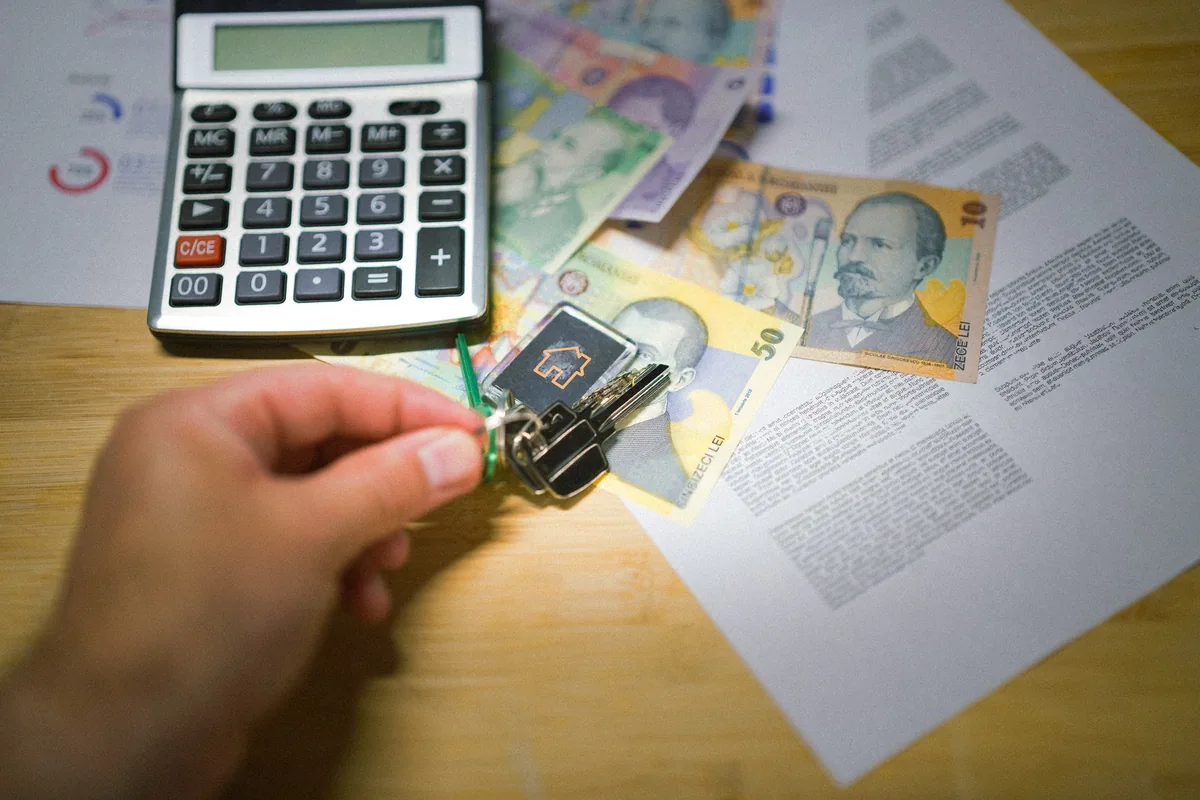 House keys, calculator and property documents used for estate valuation