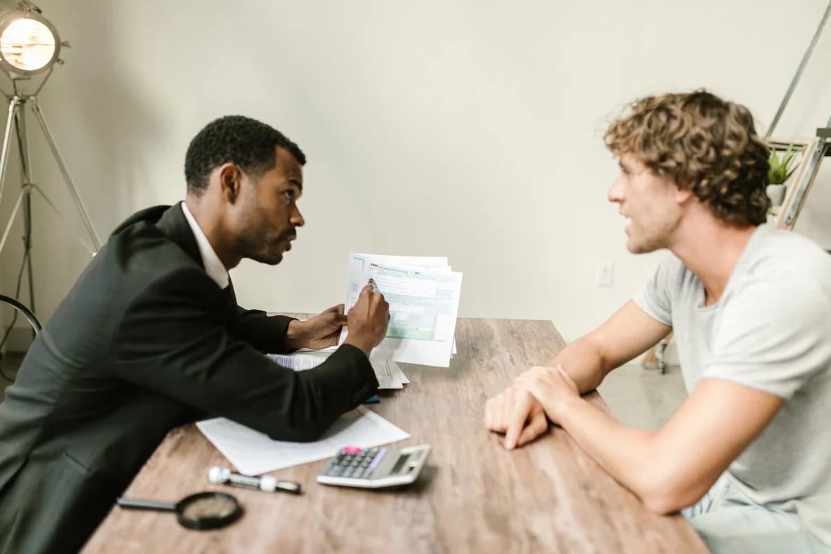 Financial advisor reviewing application documents with a business owner