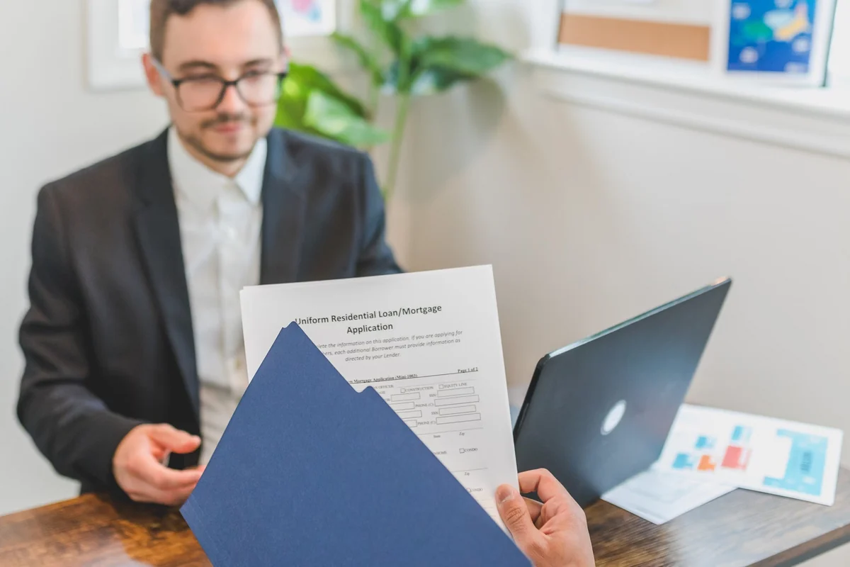 Mortgage advisor reviewing loan documents with a client