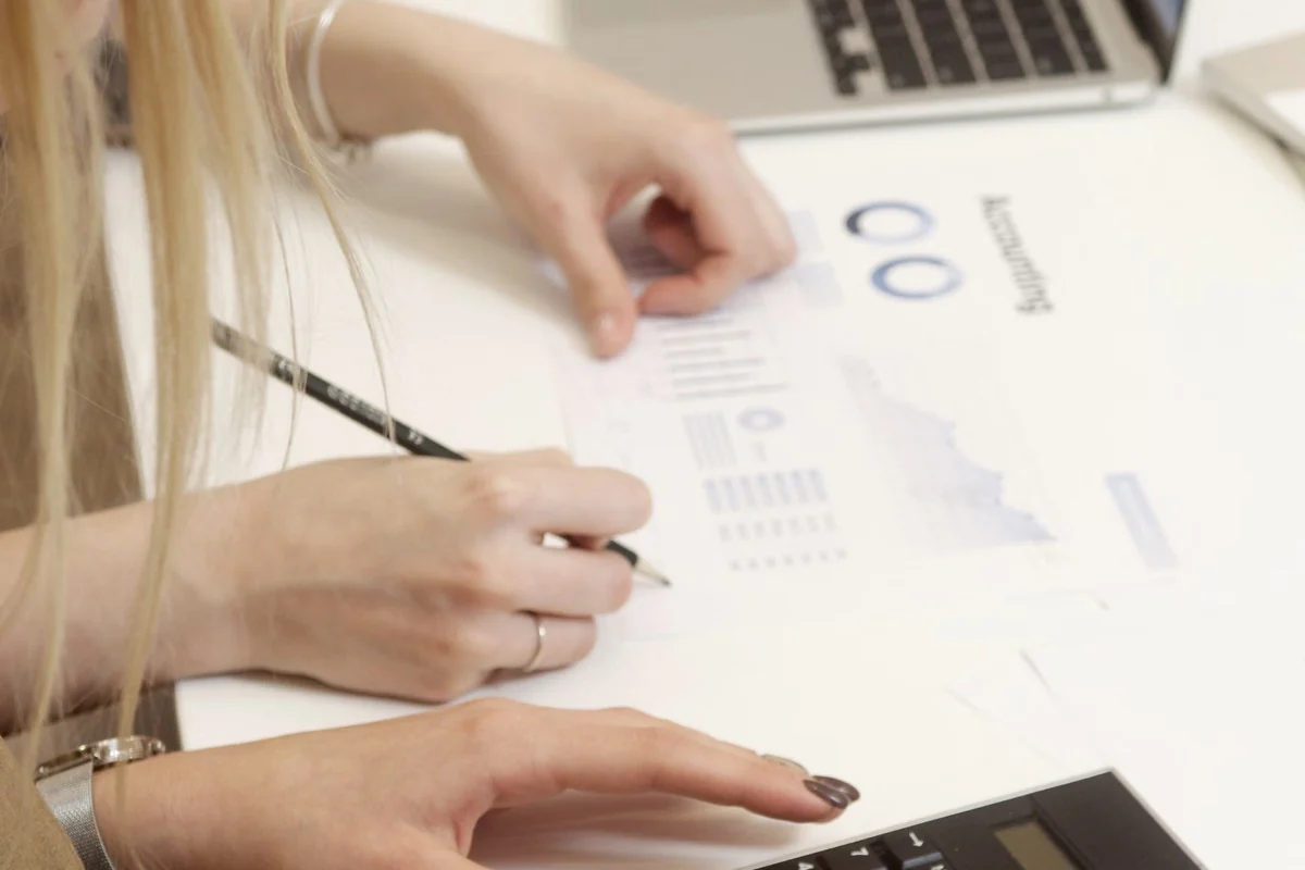 Team calculating payroll figures with financial reports