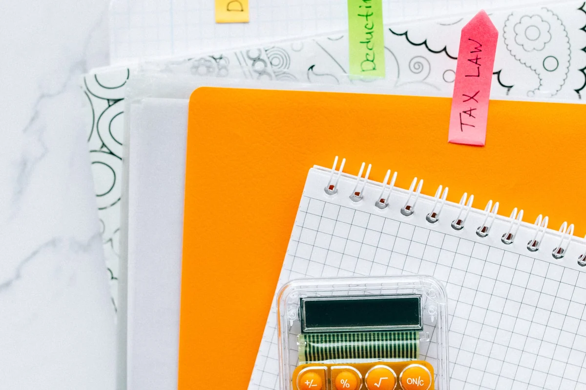 Calculator and organized financial documents on an office desk