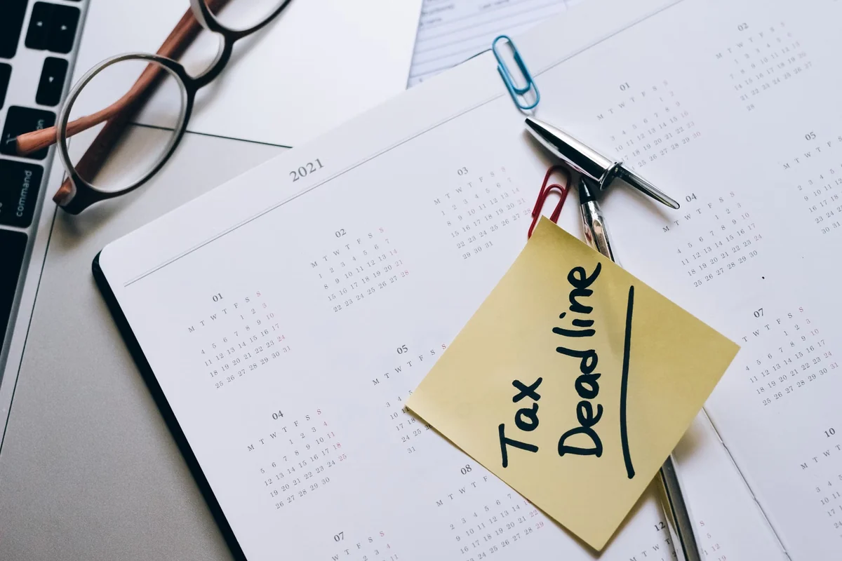 Tax deadline calendar beside office documents