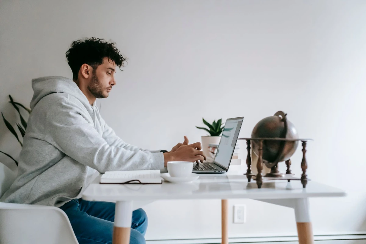 Man working remotely on a laptop at home