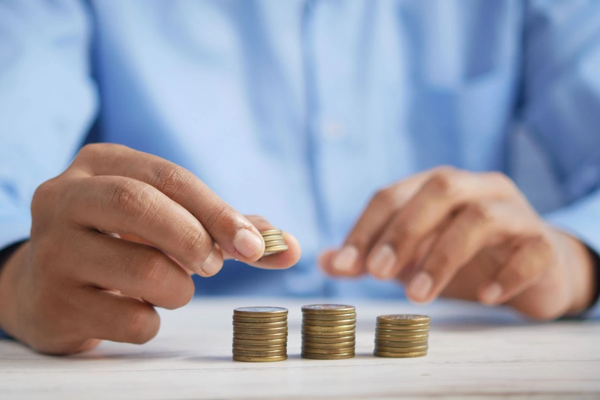 Hands carefully stacking coins