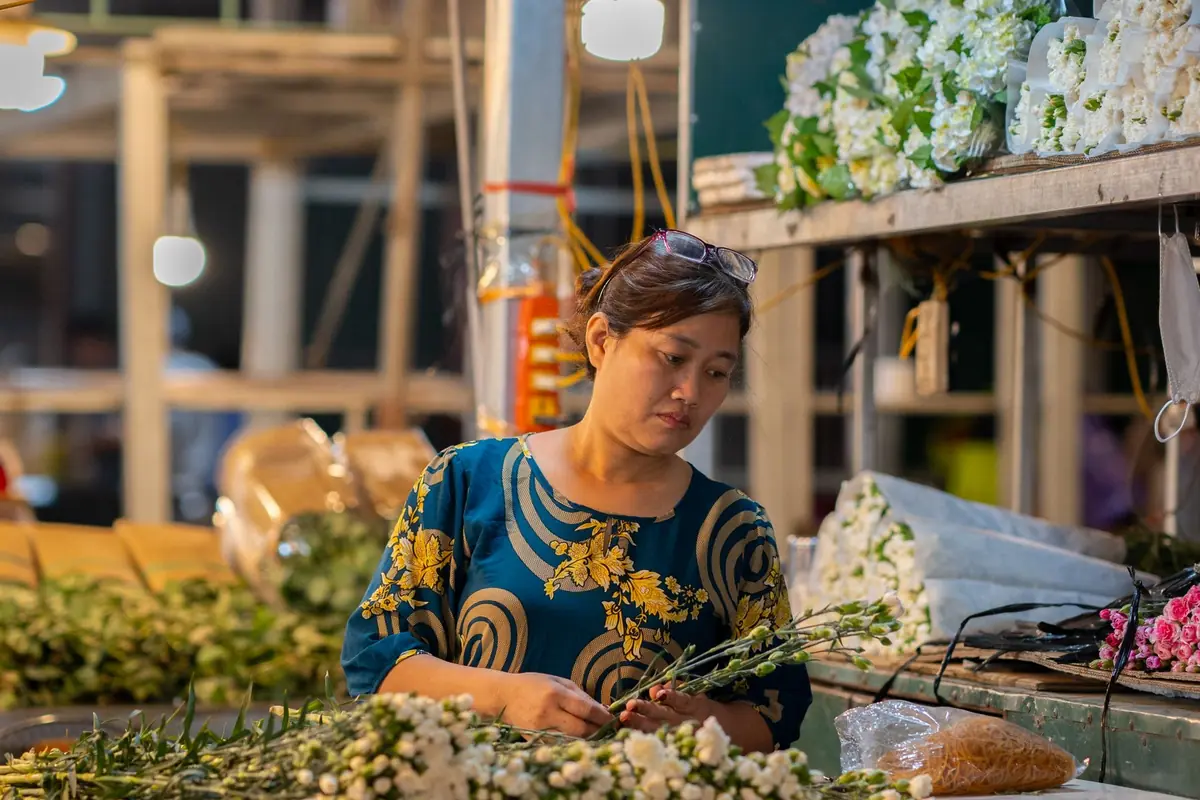 Florist arranging flowers in a small shop