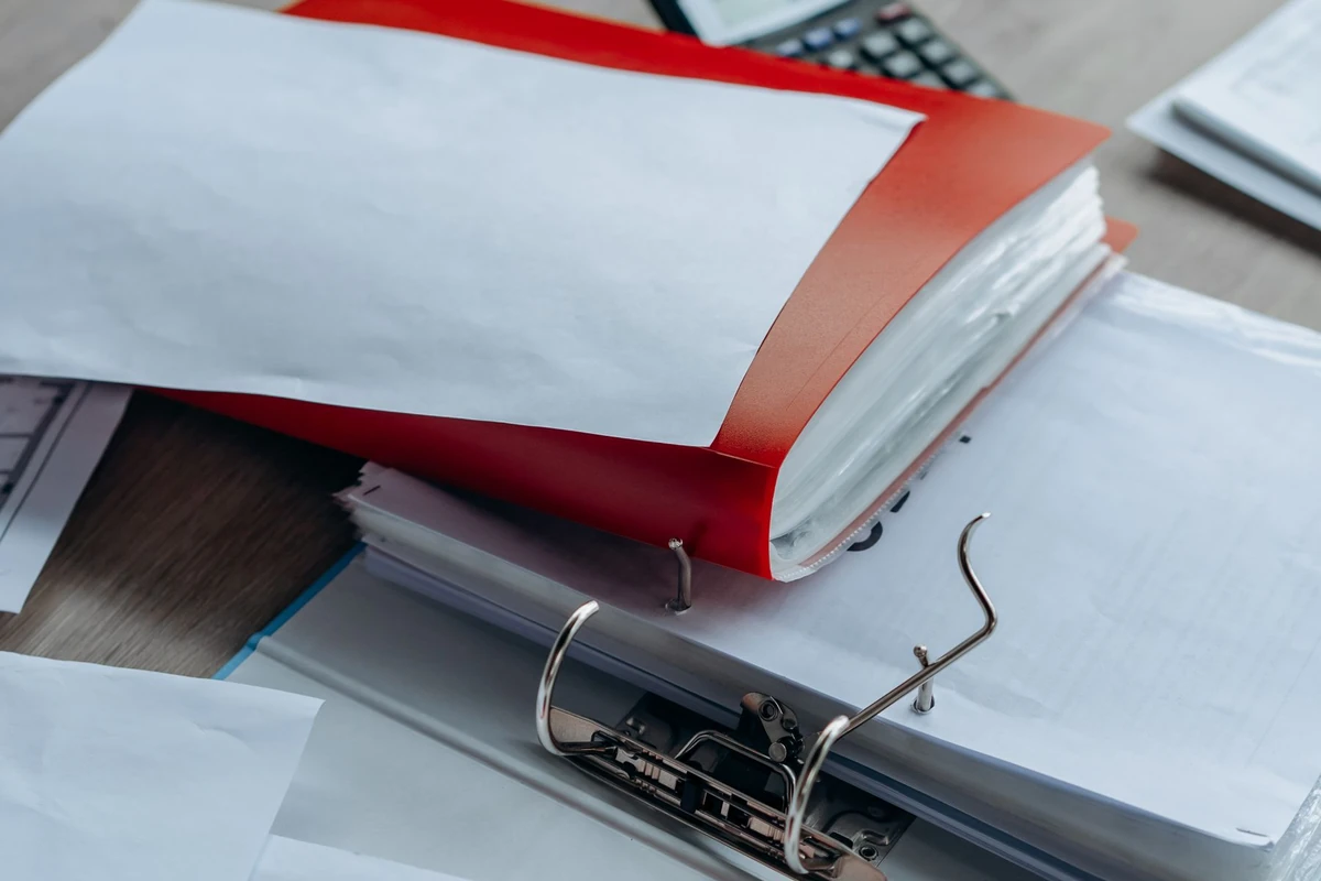 Organised binders and financial paperwork on a desk