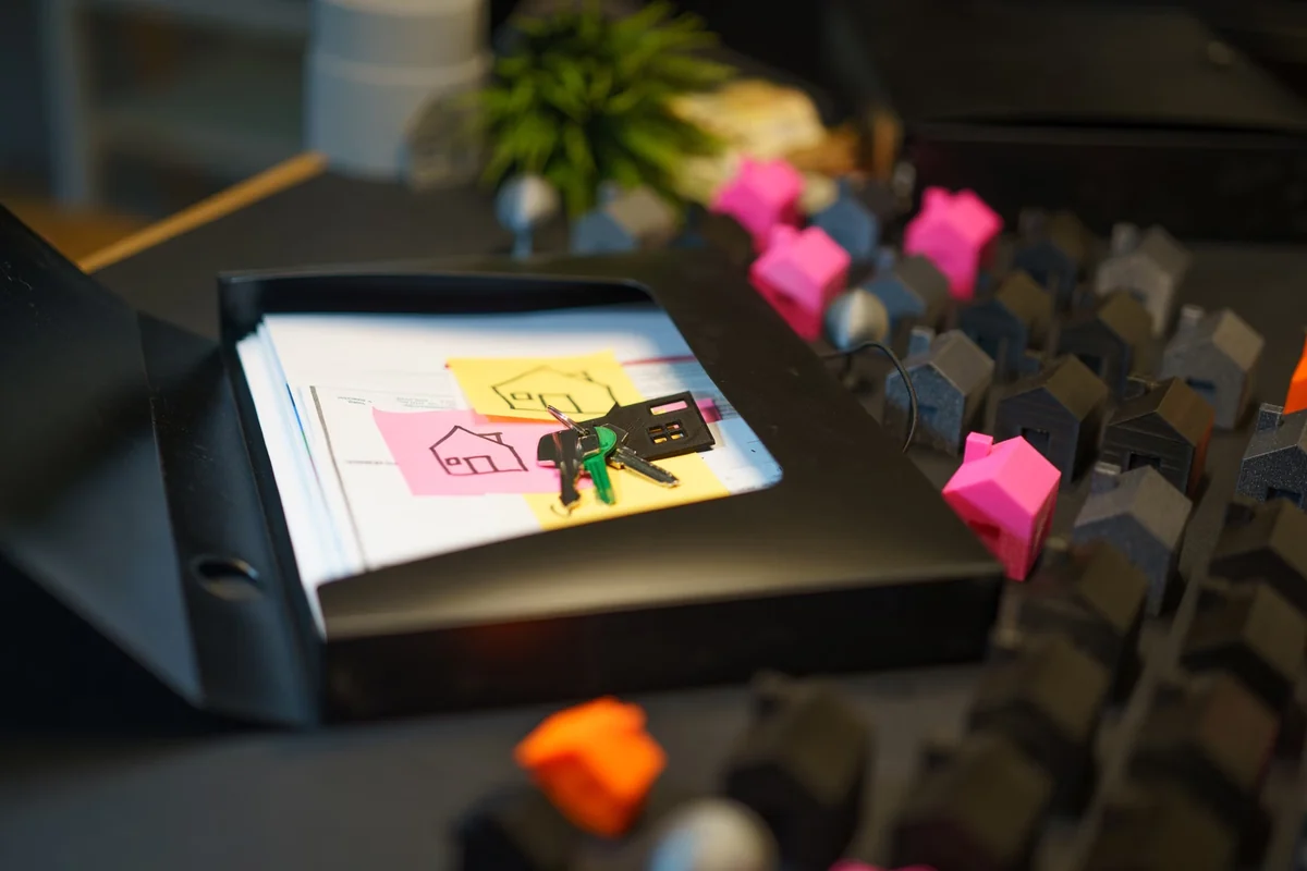 Property keys and ownership documents beside house models