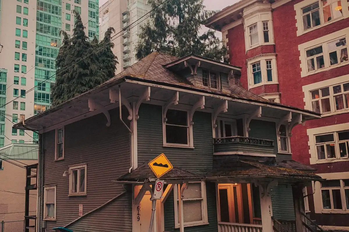 Older Vancouver house surrounded by modern city buildings