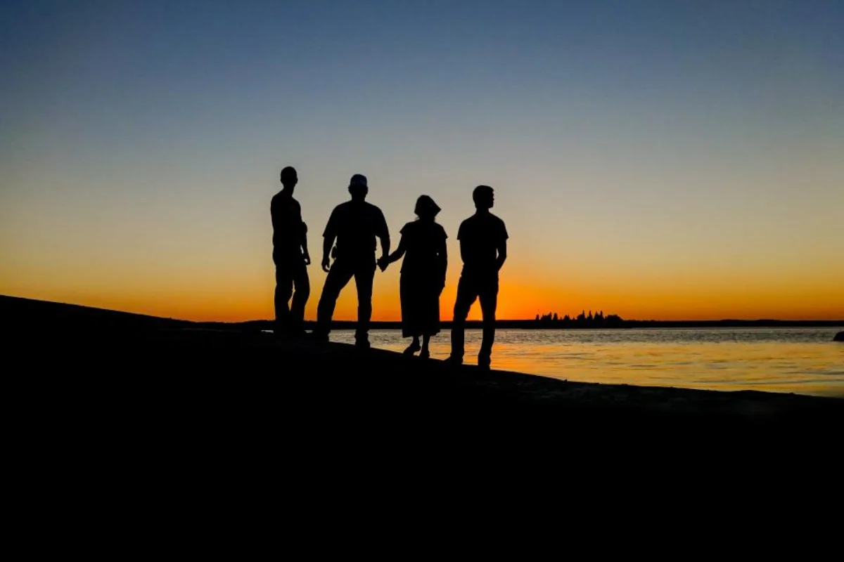 Silhouette of a family at sunset, planning the tax benefits of a trust after TOSI