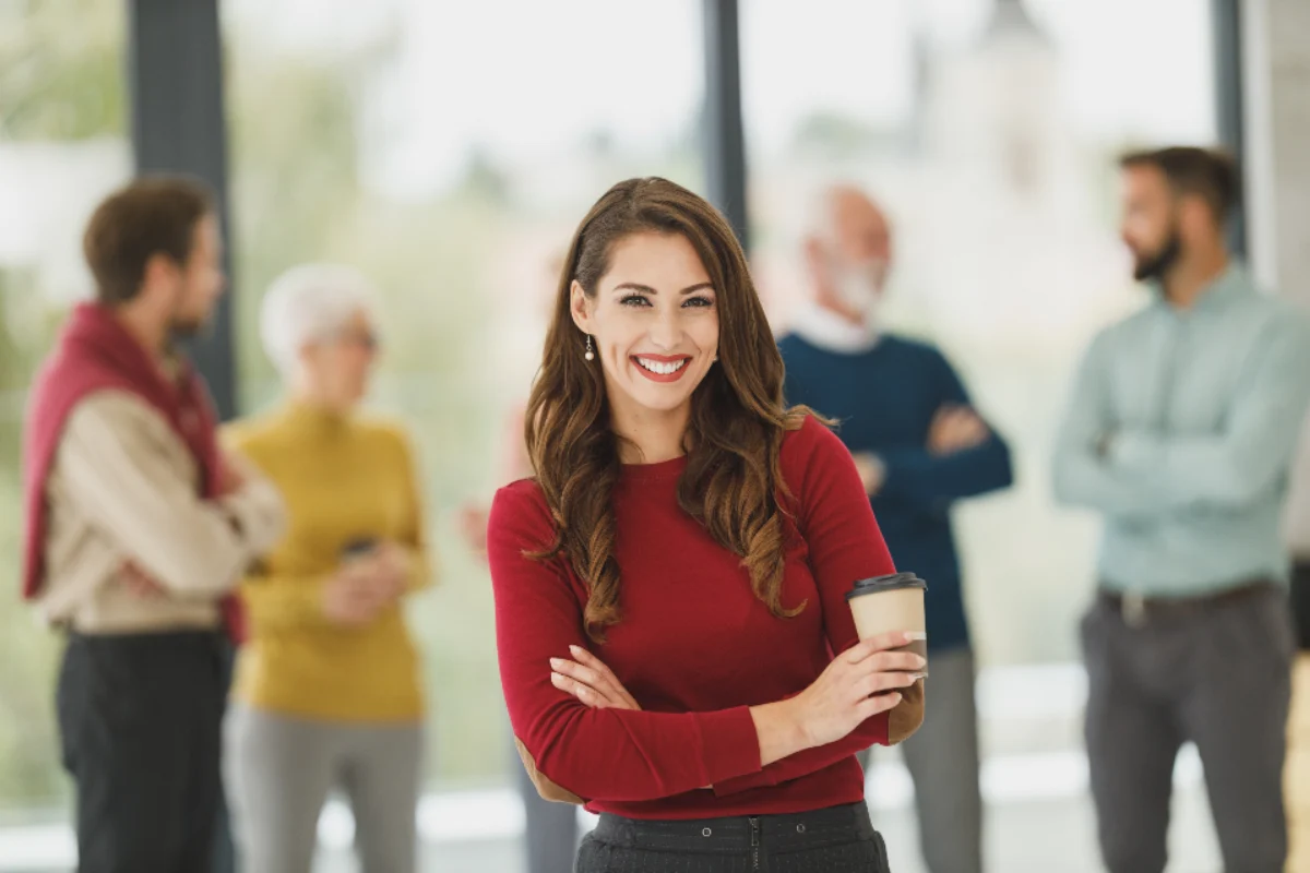 Business partner standing with colleagues, representing shared liability in a partnership