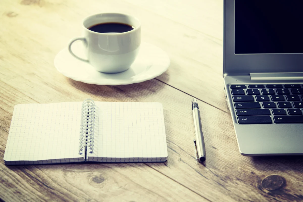 Notebook, laptop and coffee for comparing flow-through and corporate taxation