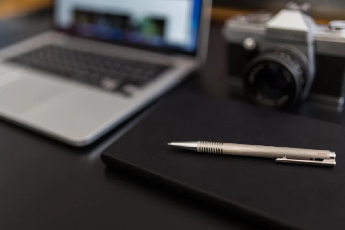 Notebook and pen for a step-by-step retained earnings calculation
